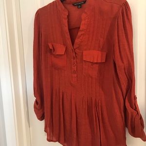Burnt orange blouse with buttons. Peplum style